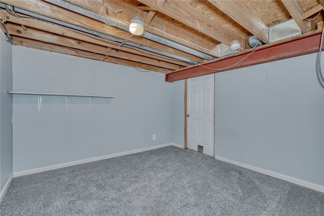 unfinished below grade area with carpet floors and baseboards