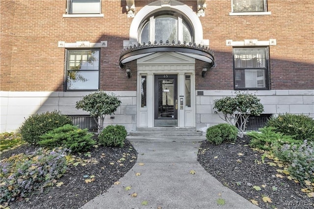 entrance to property with brick siding