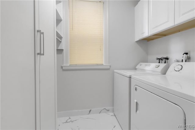 laundry area with cabinet space, baseboards, marble finish floor, and independent washer and dryer