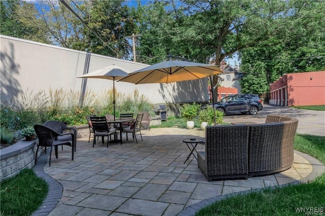 view of patio with outdoor dining space and fence