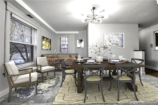 dining space with baseboards, visible vents, and an inviting chandelier