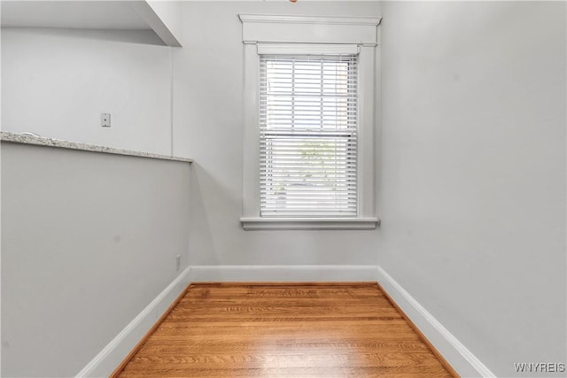 interior space featuring light wood-style flooring and baseboards