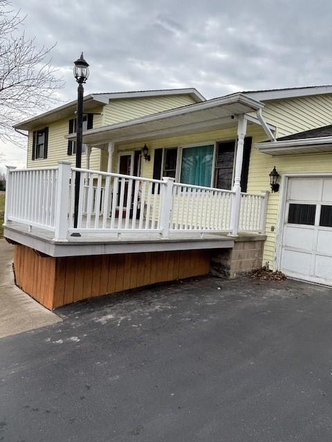 7429 Cherry Street Rd, Sennett, NY 13021 - view of front facade with aphalt driveway and a garage