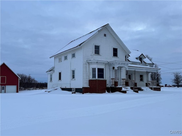 view of front facade featuring an outbuilding and a detached garage