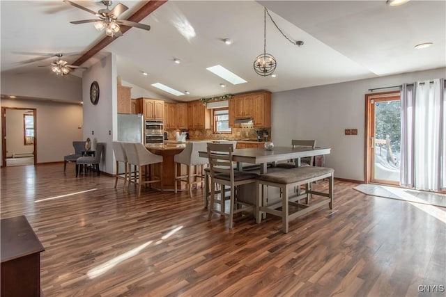 dining area featuring high vaulted ceiling, plenty of natural light, baseboards, and dark wood-type flooring