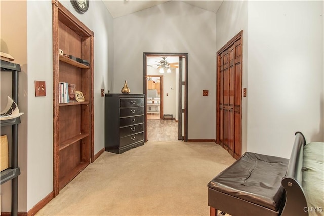 living area featuring baseboards and light colored carpet