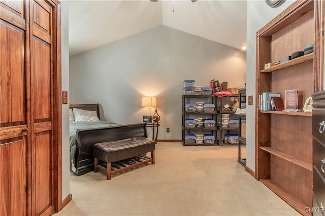 interior space featuring a ceiling fan, carpet, vaulted ceiling, and baseboards