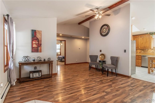 living area with ceiling fan, baseboards, baseboard heating, light wood-type flooring, and beam ceiling