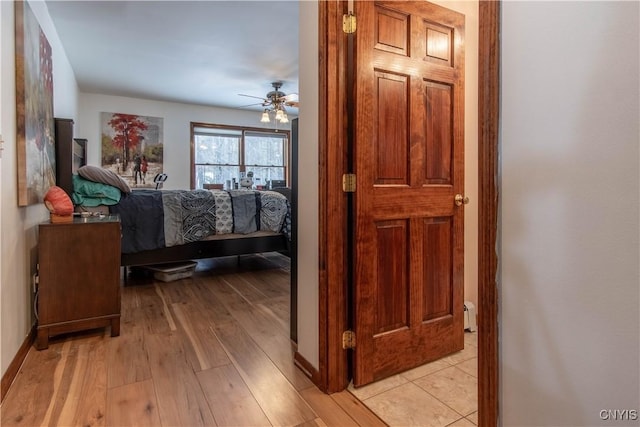 bedroom featuring light wood finished floors and ceiling fan