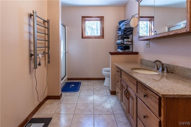 bathroom with a stall shower, baseboards, toilet, tile patterned flooring, and vanity