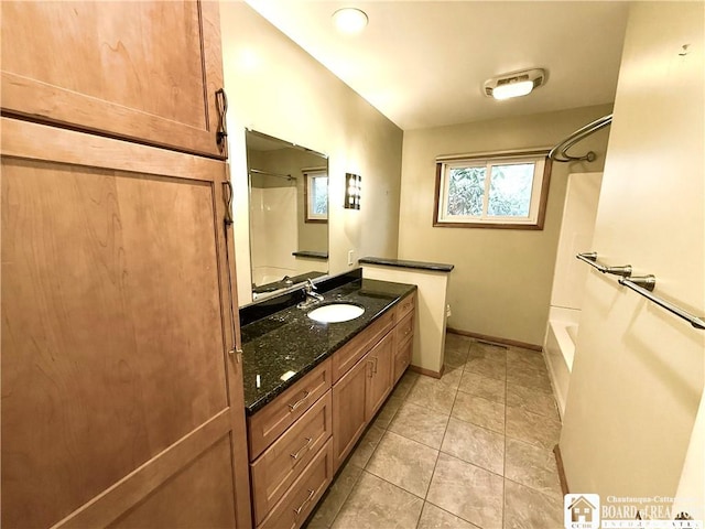 full bathroom featuring toilet, vanity, shower / tub combination, baseboards, and tile patterned floors