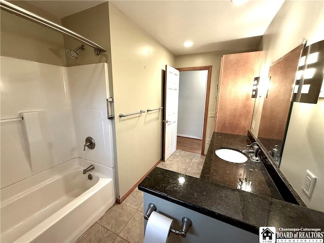 full bath with baseboards, vanity, washtub / shower combination, and tile patterned floors