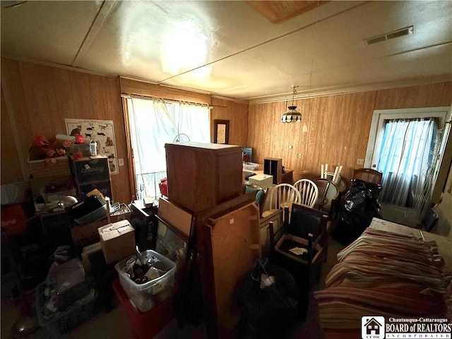 miscellaneous room featuring wood walls and visible vents