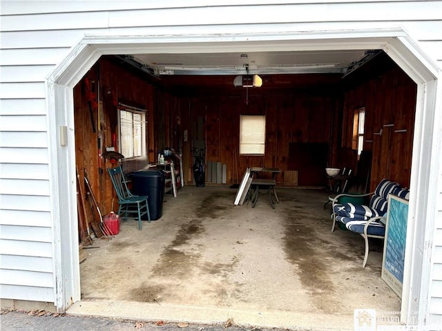 garage featuring wood walls and a garage door opener