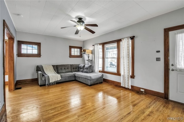 unfurnished living room featuring light wood-style flooring, visible vents, baseboards, and a ceiling fan