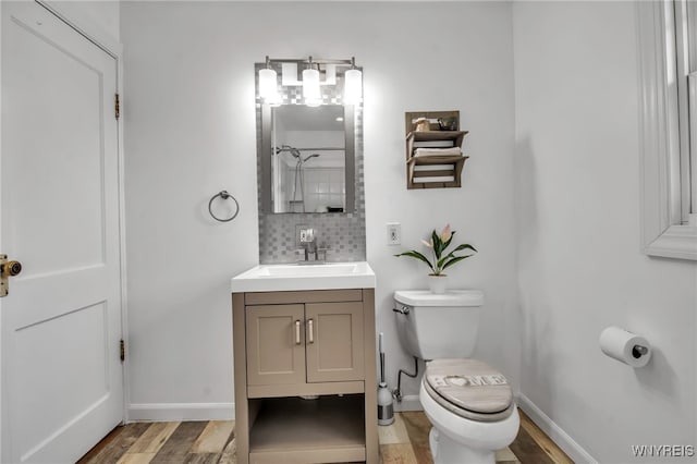 full bathroom featuring a shower, tasteful backsplash, toilet, vanity, and wood finished floors