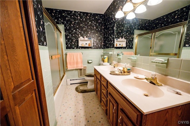 bathroom featuring a baseboard heating unit, wainscoting, a sink, and wallpapered walls