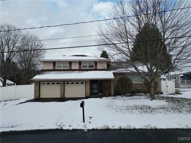 view of front of house featuring a garage and fence