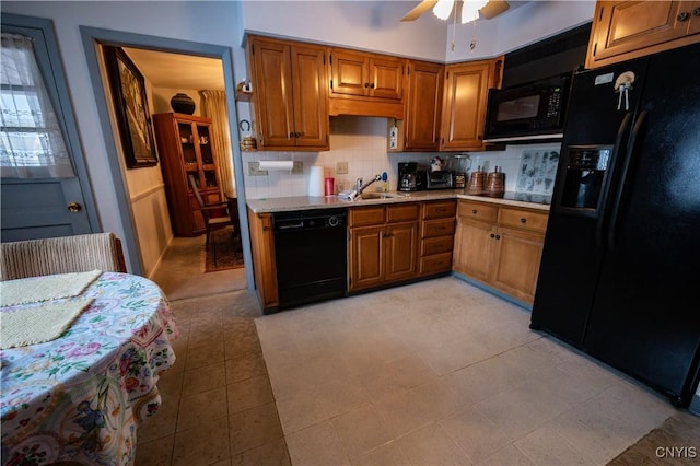 kitchen featuring brown cabinets, black appliances, light countertops, and decorative backsplash