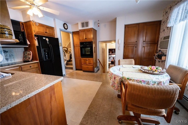 kitchen with light stone counters, visible vents, decorative backsplash, black appliances, and brown cabinetry