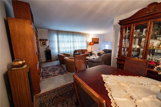 dining area with carpet and a baseboard heating unit