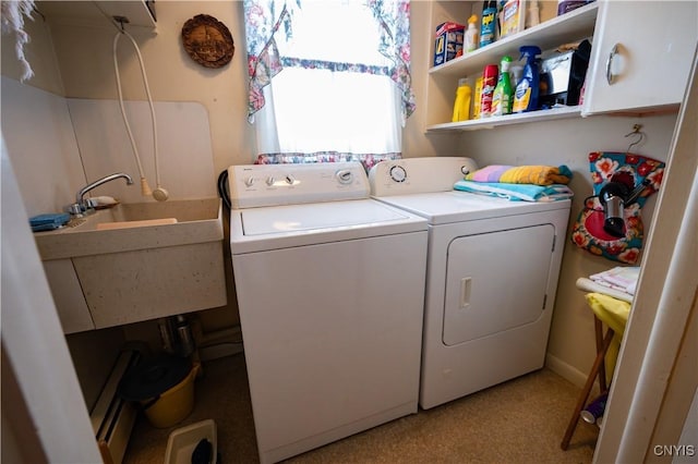 laundry room with cabinet space, a sink, and separate washer and dryer