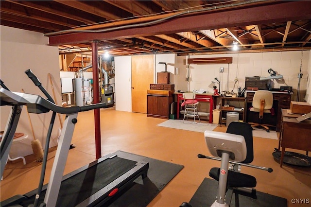 workout area with concrete block wall and gas water heater