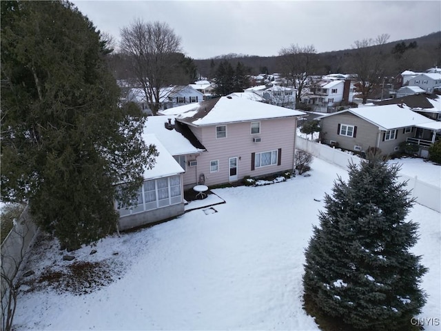 snowy aerial view with a residential view