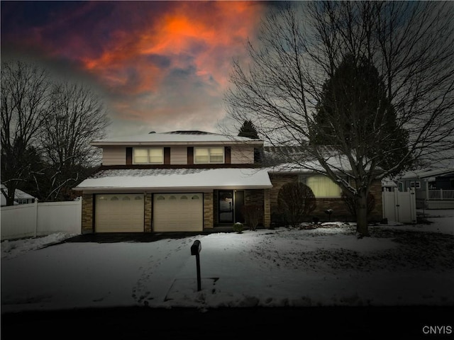 view of front of house with fence and driveway