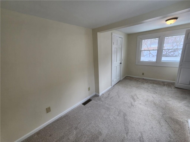 unfurnished bedroom featuring carpet, visible vents, and baseboards