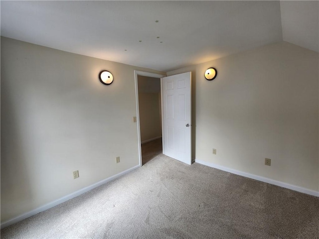 unfurnished room with light carpet and baseboards