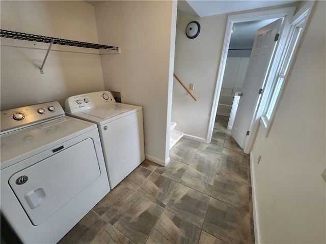 laundry area featuring washer and dryer, laundry area, and baseboards