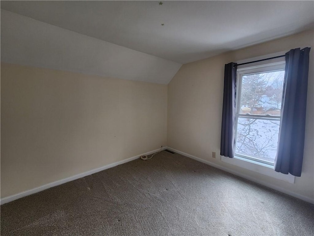 additional living space with carpet, vaulted ceiling, and baseboards