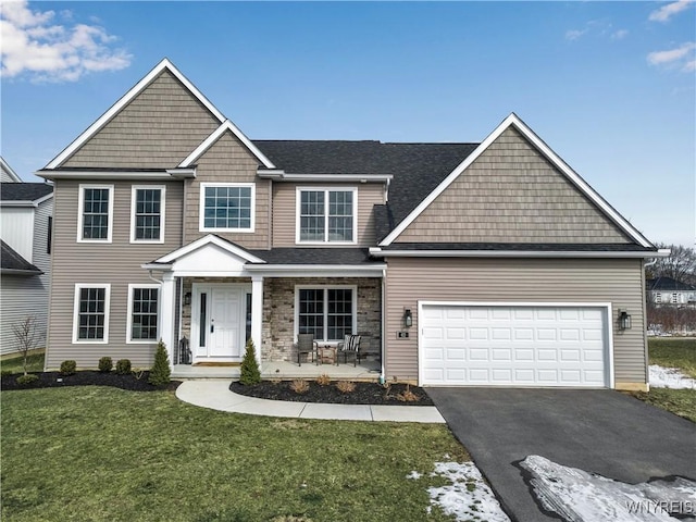 view of front facade featuring driveway, a garage, and a front yard