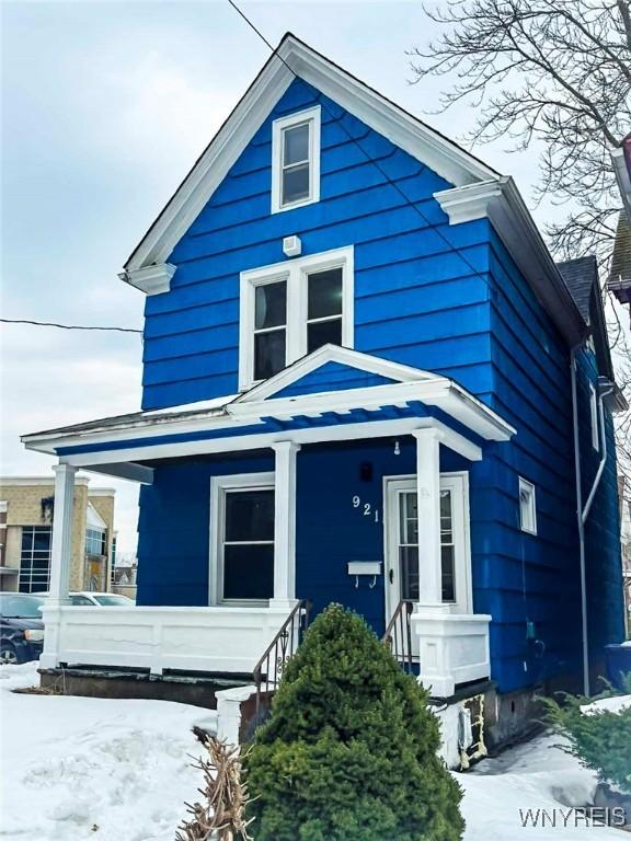 american foursquare style home featuring a porch