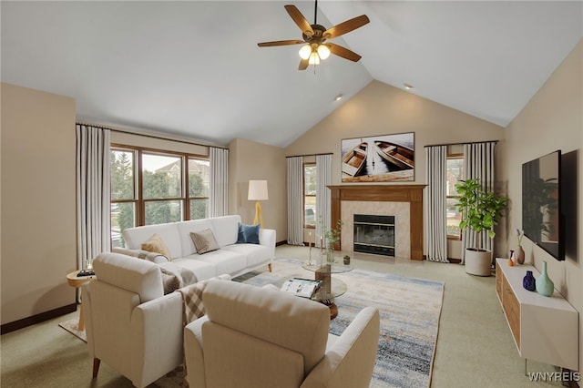 living room with a ceiling fan, a high end fireplace, light carpet, high vaulted ceiling, and baseboards