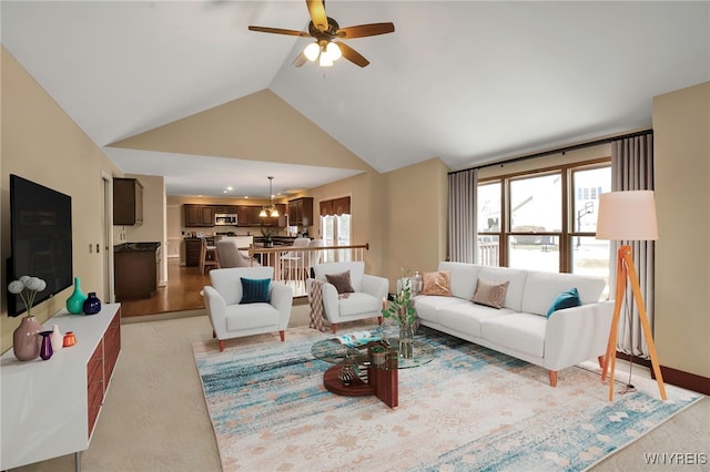 living area with a wealth of natural light, ceiling fan, and lofted ceiling