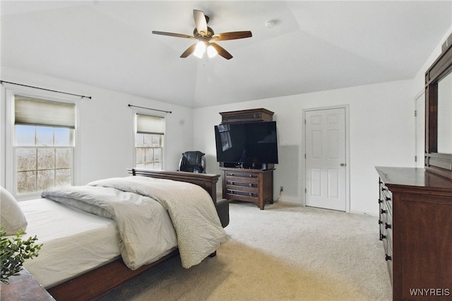 bedroom featuring lofted ceiling, a ceiling fan, and light colored carpet