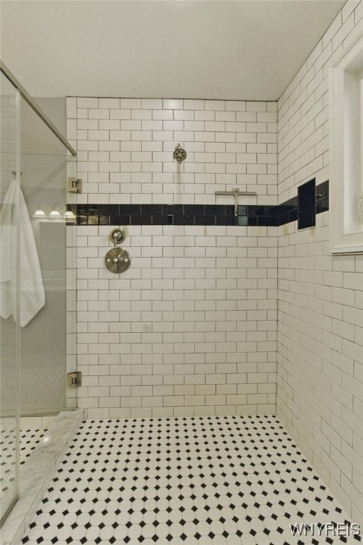 full bathroom featuring a stall shower and tile patterned flooring