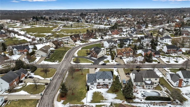 snowy aerial view with a residential view