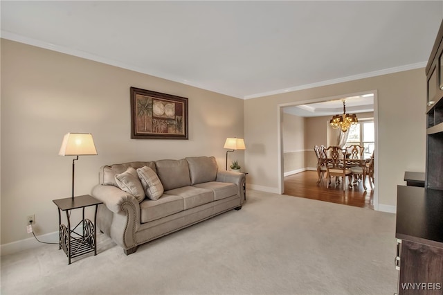 carpeted living area with baseboards, a notable chandelier, and crown molding