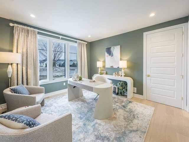 living area with recessed lighting, baseboards, and wood finished floors