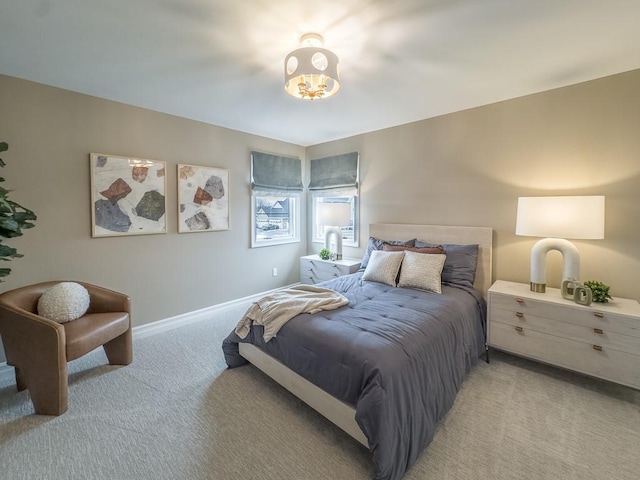 bedroom with light carpet and baseboards