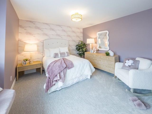 carpeted bedroom with an accent wall