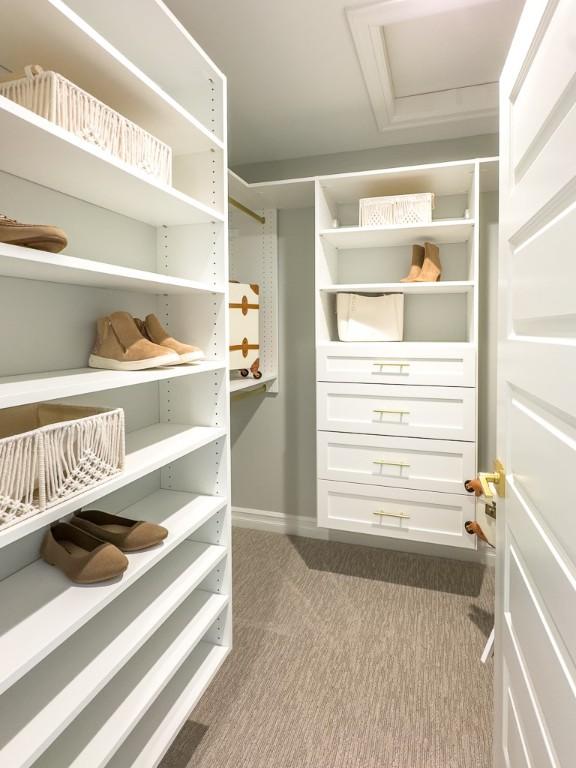 walk in closet featuring dark colored carpet and attic access