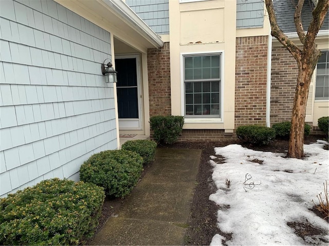 doorway to property with brick siding