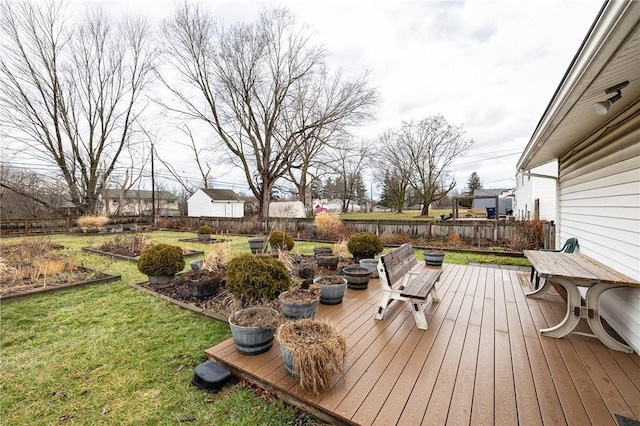 wooden deck featuring a yard and fence