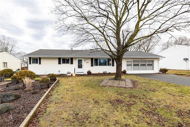 ranch-style house featuring aphalt driveway, a front yard, and a garage