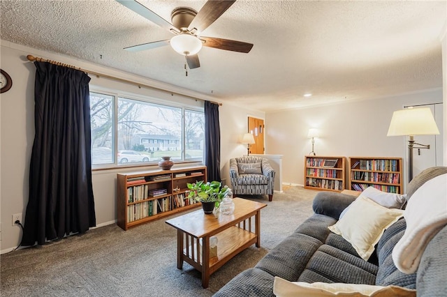 carpeted living room with a textured ceiling, a ceiling fan, and baseboards