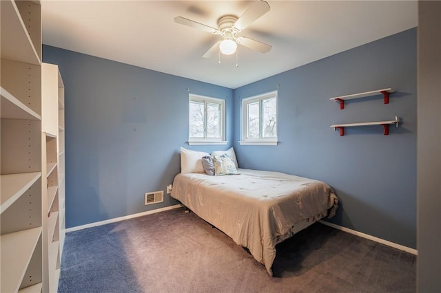 carpeted bedroom featuring a ceiling fan, visible vents, and baseboards